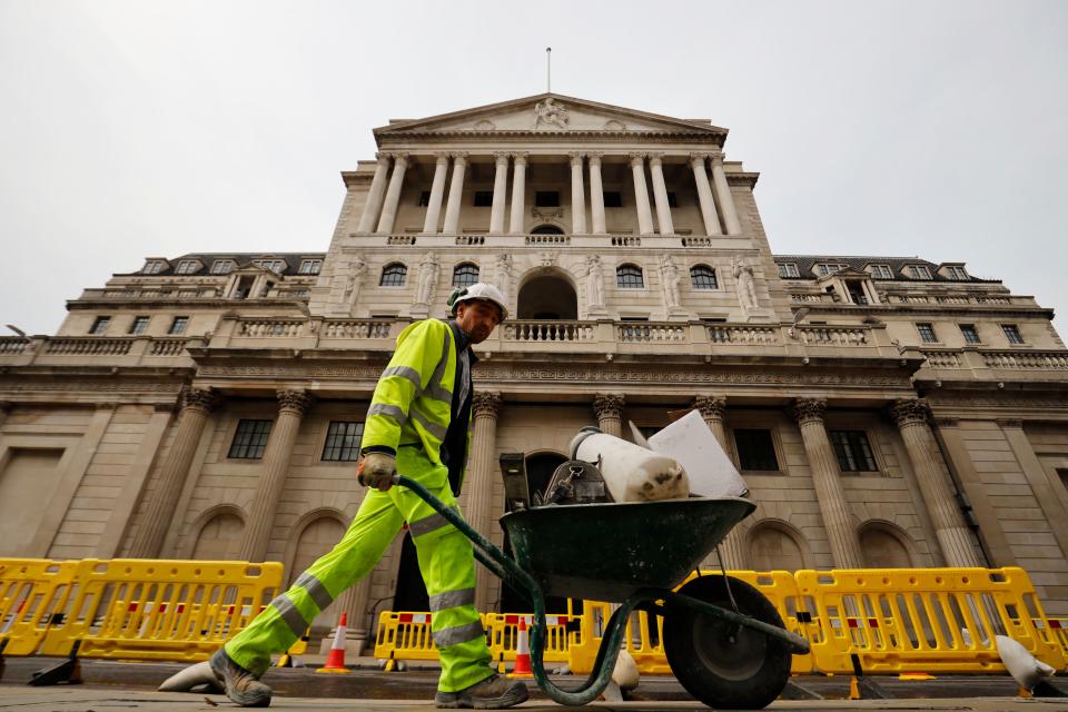 A worker pushes a wheelbarrow of debris outside the Bank of England in London on June 17, 2020. - The Bank of England, confronted by Britain's collapsing coronavirus-ravaged economy, will on June 18 reveal the outcome of its latest monetary policy meeting with analysts predicting more stimulus. The British central bank has been at the forefront of economic fire-fighting over this year's deadly COVID-19 emergency -- and could expand its quantitative easing (QE) stimulus in an attempt to kickstart growth. (Photo by Tolga Akmen / AFP) (Photo by TOLGA AKMEN/AFP via Getty Images)