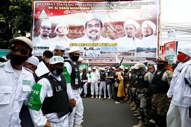 People gather for the homecoming of Rizieq Shihab, the leader of Indonesian Islamic Defenders Front (FPI) who has resided in Saudi Arabia since 2017