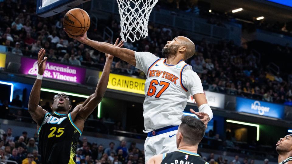 Dec 30, 2023; Indianapolis, Indiana, USA; New York Knicks forward Taj Gibson (67) rebounds the ball while Indiana Pacers forward Jalen Smith (25) defends in the second half at Gainbridge Fieldhouse.