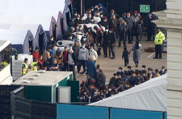 People thought to be migrants wait to be processed at the Border Force compound in Dover, Kent, (Photo: Gareth Fuller - PA Images via Getty Images)