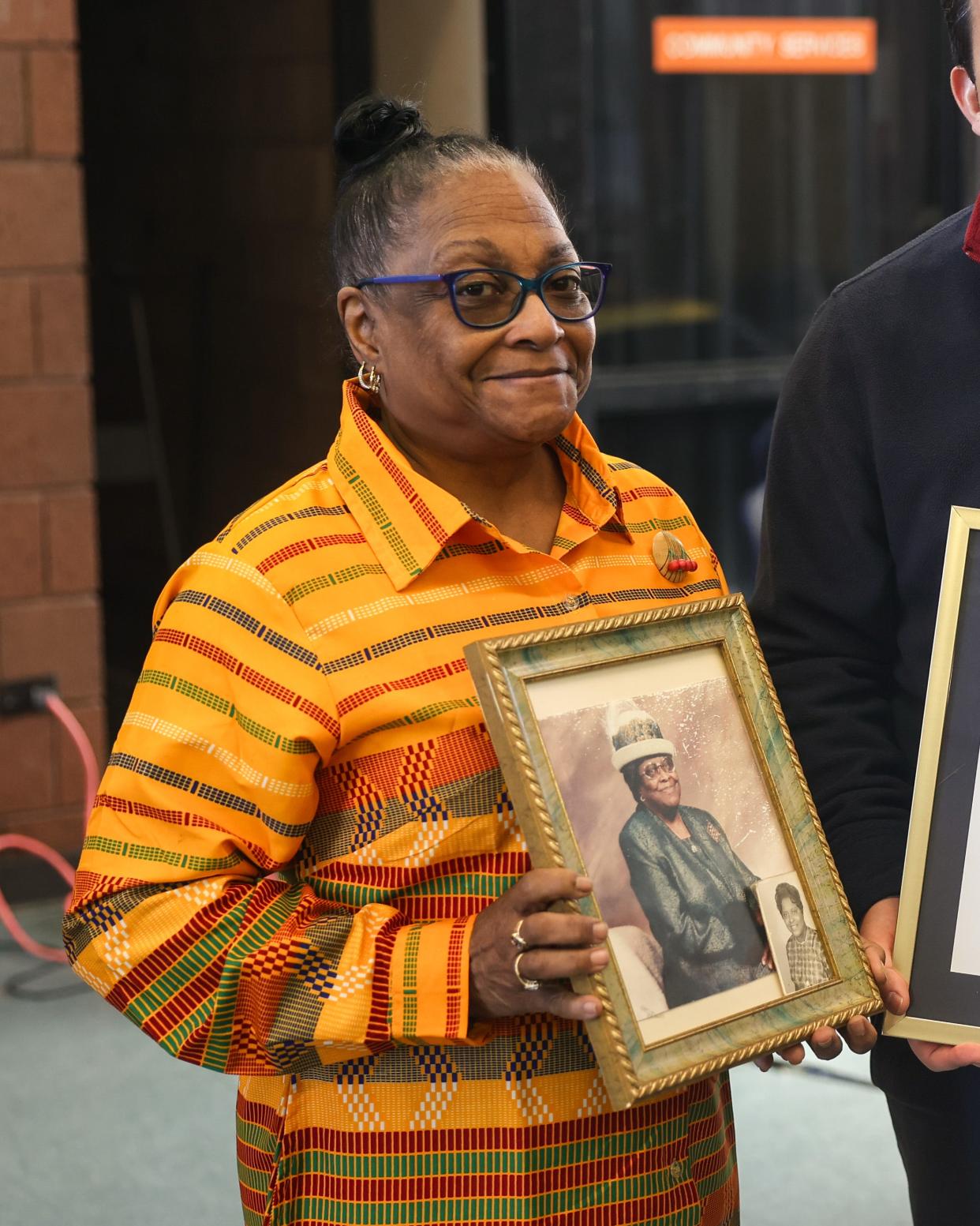 Jackie Gordon, daughter of 101-year old Rosie L. Davis, holds her mother’s photo after she and other centenarians were honored by a mayoral proclamation during the Joy Park Neighborhood Federation’s Black History Month program Saturday.