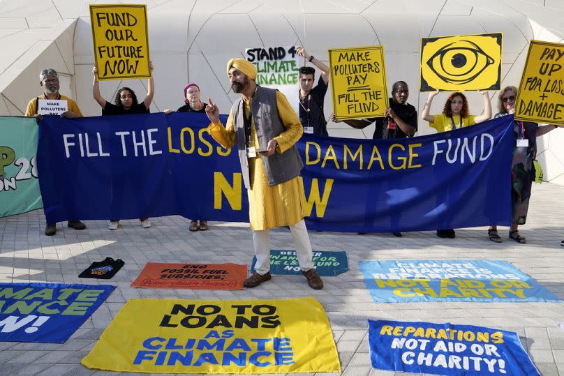 Activists participate in a demonstration for loss and damage at COP28.