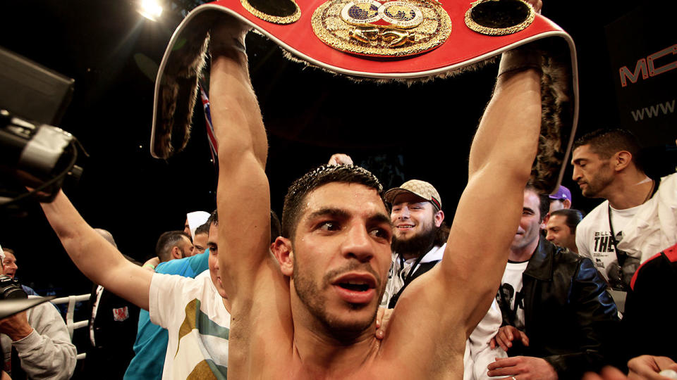 Pictured here, Billy Dib holds the IBF Featherweight belt aloft after beating Jorge Lacierva in 2011.