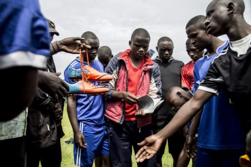 Former Democratic Liberation Forces of Rwanda fighters prepare to play football at Mutobo's reintegration centre -- but reconciliation attempts cannot hide the fact 1,012 international arrest warrants are out for suspects in 32 countries