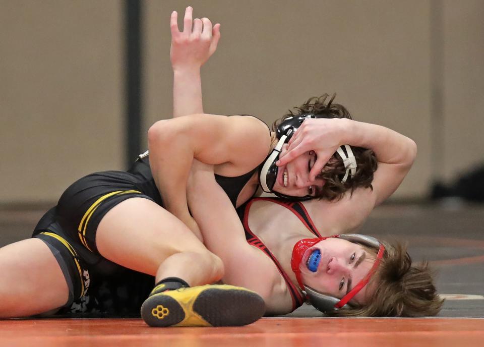 Perry's Liston Seibert, top, works over Mentor's Jack DeBoe during a 120-pound Division I semifinal at the North Canton district, Saturday, March 4, 2023.