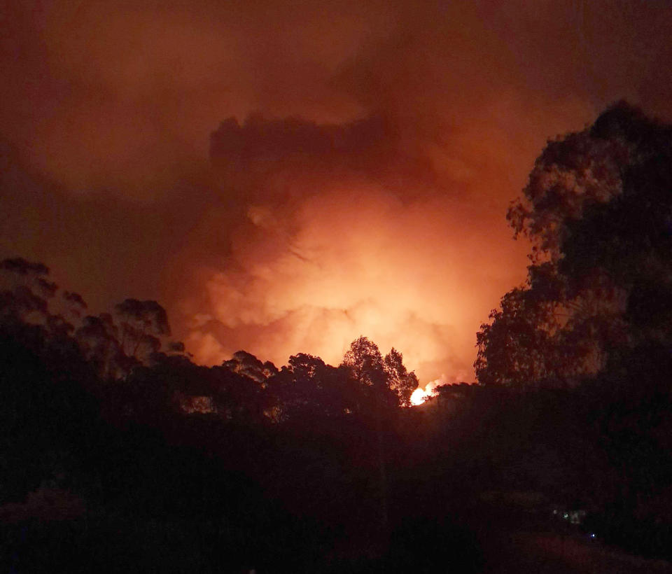 In this Dec. 31, 2019, photo provided by Siobhan Threlfall, a fire approaches the village of Nerrigundah, Australia. The tiny village has been among the hardest hit by Australia's devastating wildfires, with about two thirds of the homes destroyed and a 71-year-old man killed. (AP Photo/Siobhan Threlfall)