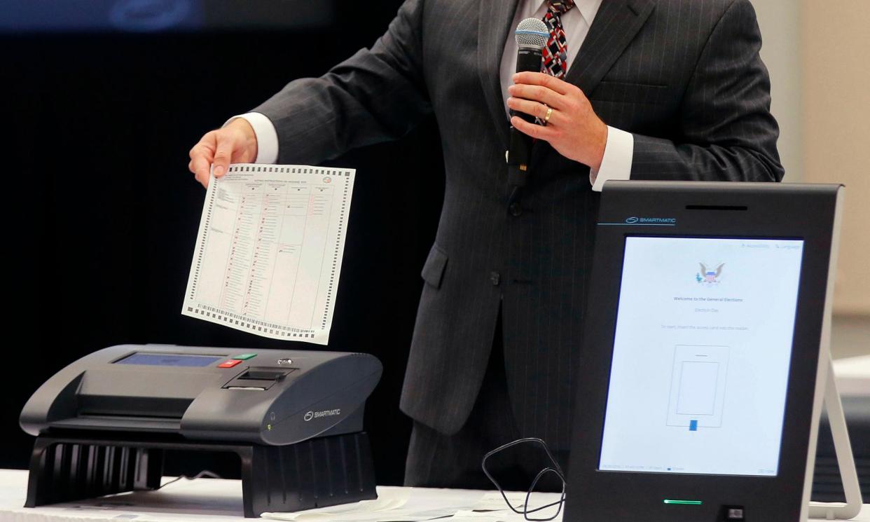 <span>A Smartmatic representative demonstrates his company's system on 30 August 2018 in Grovetown, Georgia.</span><span>Photograph: Bob Andres/AP</span>