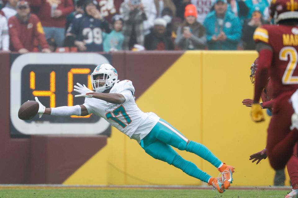 Dec 3, 2023; Landover, Maryland, USA; Miami Dolphins wide receiver Jaylen Waddle (17) attempts to catch a pass against the Washington Commanders during the second quarter at FedExField. Mandatory Credit: Geoff Burke-USA TODAY Sports