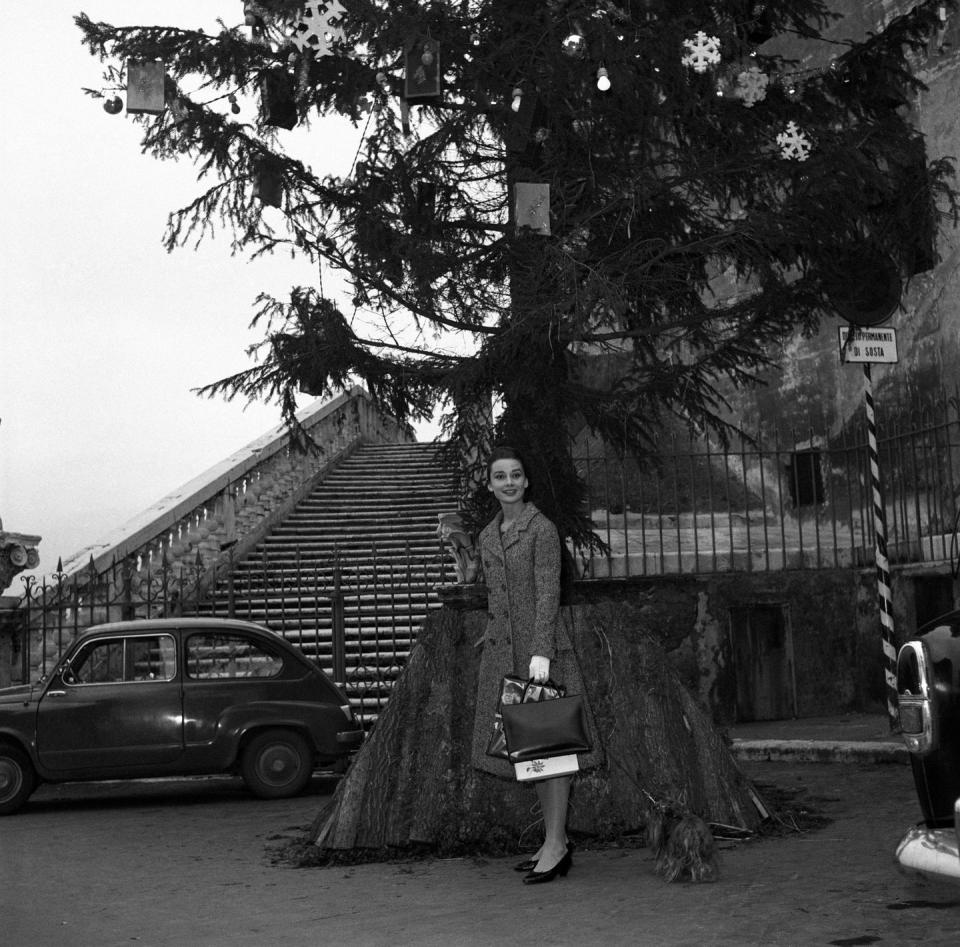 <p>The actress looks pint-sized compared to the massive decorated Christmas tree the actress is posing next to while visiting Rome over the holidays. </p>