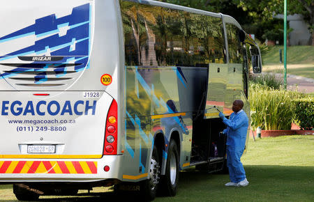 A forensic investigator searches for clues on a bus alleged to have been used by the 36 Dutch tourists who were robbed at gunpoint on Sunday in a brazen heist while traveling from JohannesburgÕs main international airport to their hotel, officials said, in Johanneburg, South Africa, September 26 2017. REUTERS/Siphiwe Sibeko