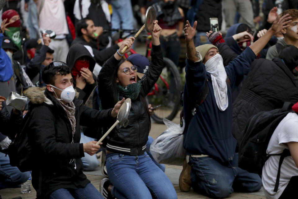Anti-government protesters rally in at the Bolivar square in downtown Bogota, Colombia, Friday, Nov. 22, 2019. Labor unions and student leaders called on Colombians to bang pots and pans Friday evening in another act of protest while authorities announced three people had died in overnight clashes with police after demonstrations during a nationwide strike. (AP Photo/Ivan Valencia)