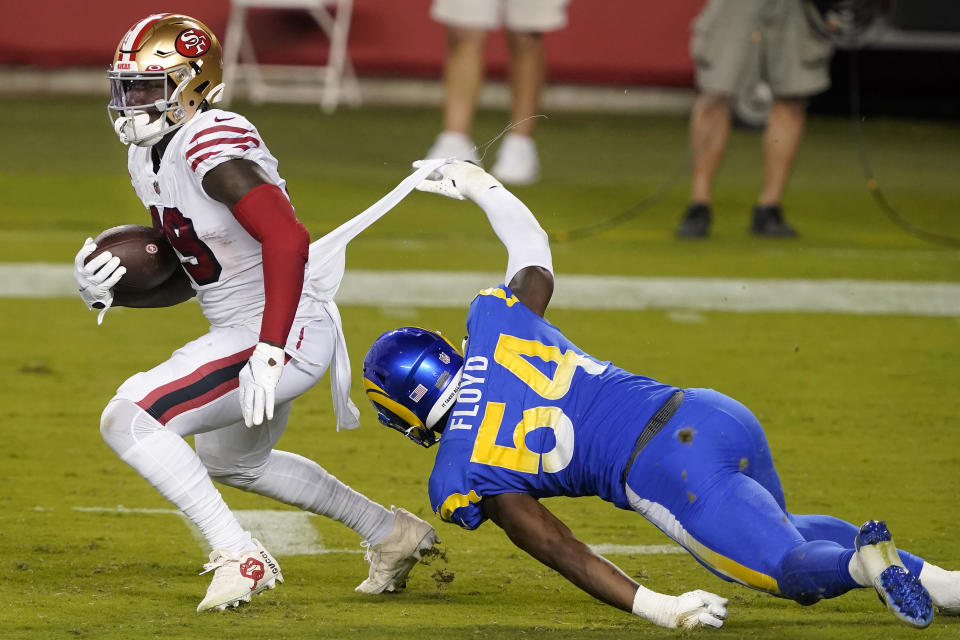 Los Angeles Rams outside linebacker Leonard Floyd (54) tackles San Francisco 49ers wide receiver Deebo Samuel during the second half of an NFL football game in Santa Clara, Calif., Sunday, Oct. 18, 2020. (AP Photo/Tony Avelar)