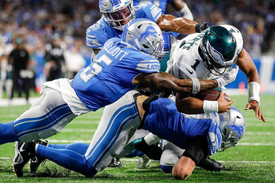 Sep 11, 2022; Detroit, Michigan, USA; Detroit Lions safety DeShon Elliott (5) stops Philadelphia Eagles quarterback Jalen Hurts (1) in front of the end zone during the first half at Ford Field. Mandatory Credit: Junfu Han-USA TODAY Sports