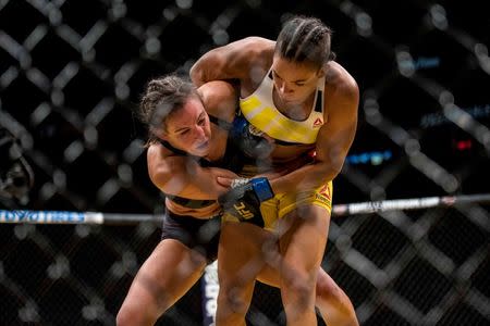 Jul 9, 2016; Las Vegas, NV, USA; Amanda Nunes (blue gloves) and Miesha Tate (red gloves) compete during UFC 200 at T-Mobile Arena. Nunez won by rear naked choke. Mandatory Credit: Joshua Dahl-USA TODAY Sports