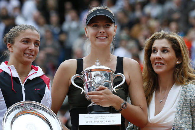 Russia's Maria Sharapova (C) and Italy's Sara Errani hold their trophies Former tennis champion Monica Seles (R) on the podium after their Women's Singles final tennis match of the French Open tennis tournament at the Roland Garros stadium, on June 9, 2012 in Paris. Sharapova won the final. AFP PHOTO / JACQUES DEMARTHONJACQUES DEMARTHON/AFP/GettyImages