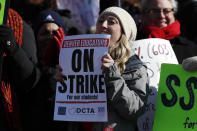 Rebecca Hendricks, a teacher at Emily Griffith High School, waves a sign during a strike rally on the west steps of the State Capitol Monday, Feb. 11, 2019, in Denver. The strike is the first for teachers in Denver since 1994 and centers on base pay. (AP Photo/David Zalubowski)