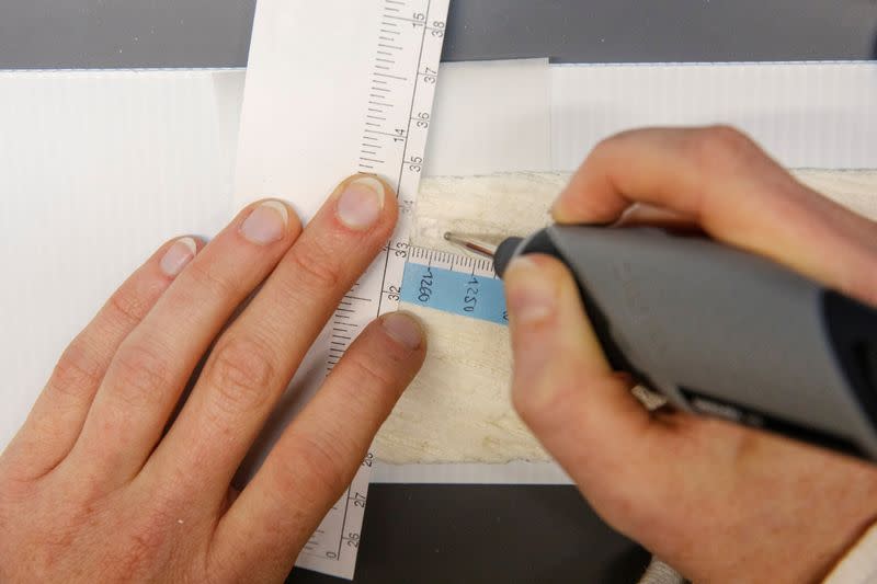 A research assistant grinds up a slice of a coral core recovered during a research trip in American Samoa in 2011 by Braddock Linsley inside of the Lamont-Doherty Earth Observatory of Columbia University in Palisades, New York