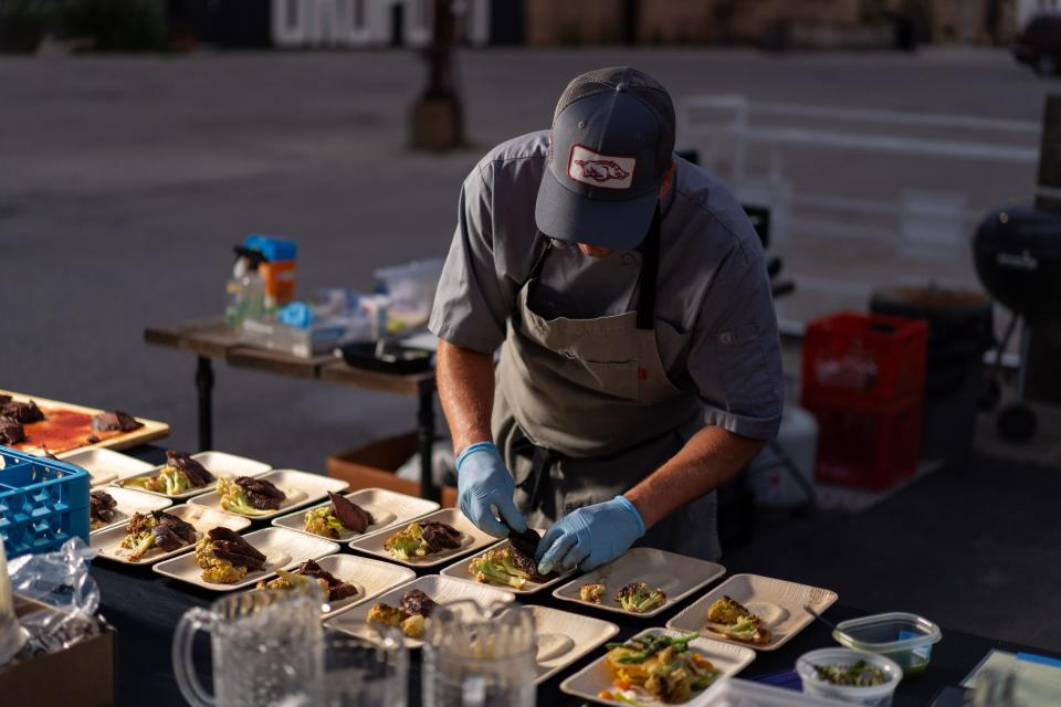 Chef Joel Lichosik plates one of the Crops on Top dinner's five courses: grilled hanger steak, charred sprouting cauliflower and Walla Walla onion soubise.