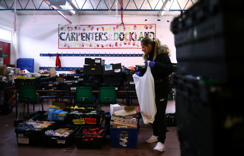 Dionne Tracey sorts food items ready to be delivered to local residents at a food bank in the Docklands Settlements Community Centre, as the spread of the coronavirus disease (COVID-19) continues, in east London