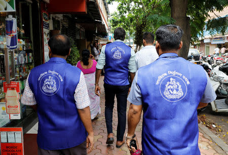 Municipal officers, who are part of a plastic eradication squad, walk through a market in Mumbai, India, June 27, 2018. REUTERS/Danish Siddiqui