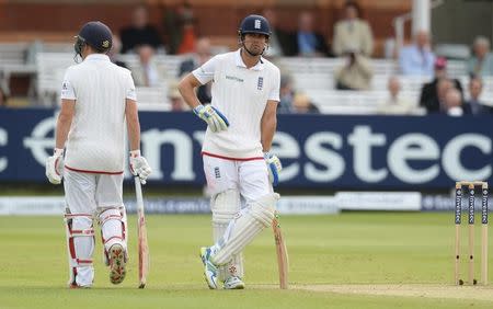 England's Alastair Cook looks dejected while Gary Ballance walks off after he was dismissed for a duck. Action Images via Reuters / Philip Brown