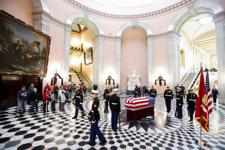 Marines stand guard as mourners wait in line to view the casket of John Glenn as he lies in honor, Friday, Dec. 16, 2016, in Columbus, Ohio. Glenn's home state and the nation began saying goodbye to the famed astronaut who died last week at the age of 95. (AP Photo/John Minchillo)
