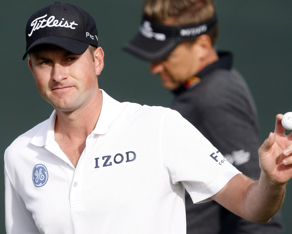 Keegan Bradley acknowledges the gallery after making his putt on the 16th hole during the first round of the Waste Management Phoenix Open golf tournament on Thursday, Jan. 30, 2014, in Scottsdale, Ariz. (AP Photo/Rick Scuteri)