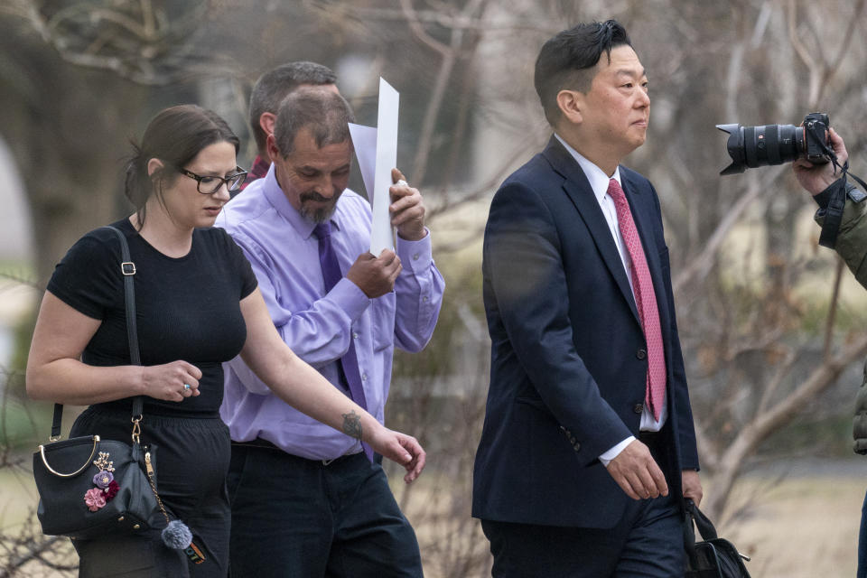 Kevin Seefried, second from left, a Delaware man who stormed the Capitol with Confederate battle flag, with his public defender Eugene Ohm, departs Federal Court after sentencing, Thursday, Feb. 9, 2023, in Washington. Seefried, who threatened a Black police officer with a pole attached to a Confederate battle flag as he stormed the U.S. Capitol on Jan. 6, 2021, has been sentenced to three years in prison. (AP Photo/Alex Brandon)