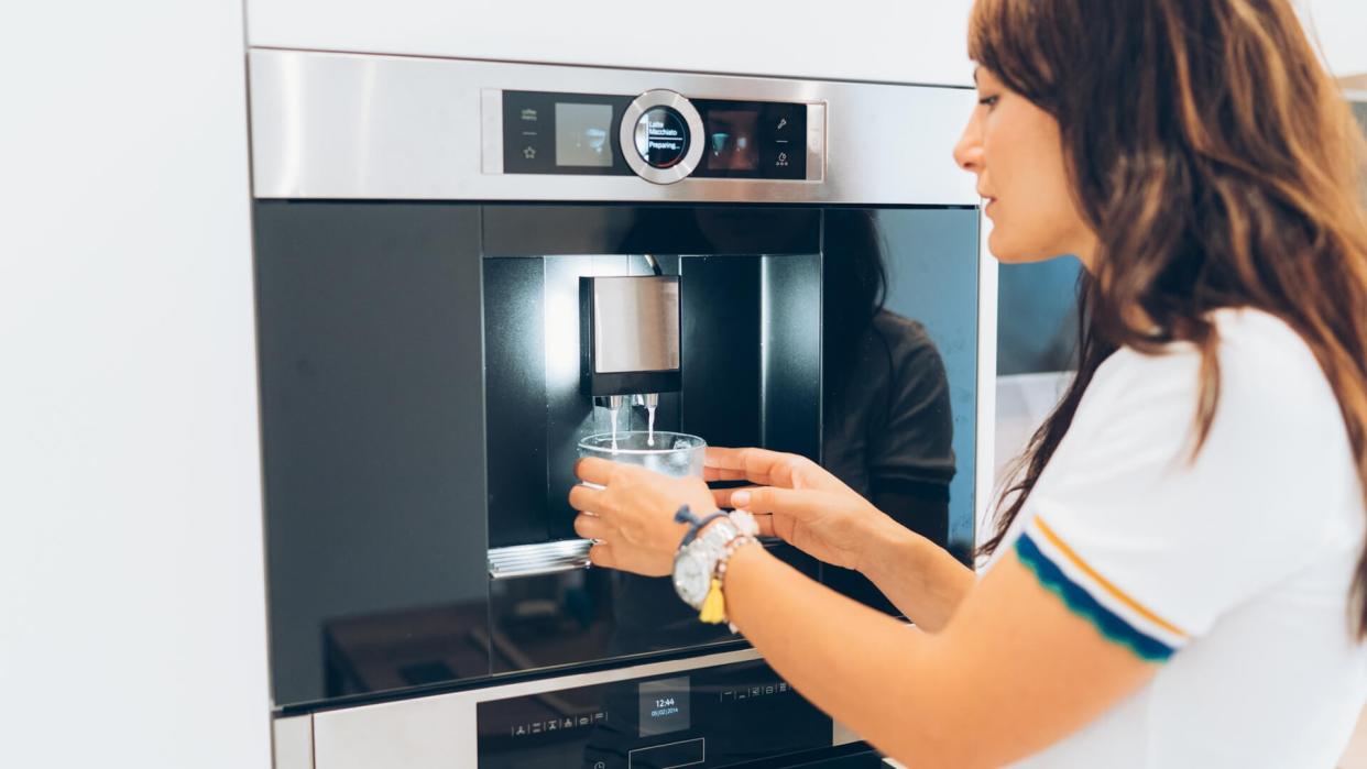 Young woman making her morning coffee.