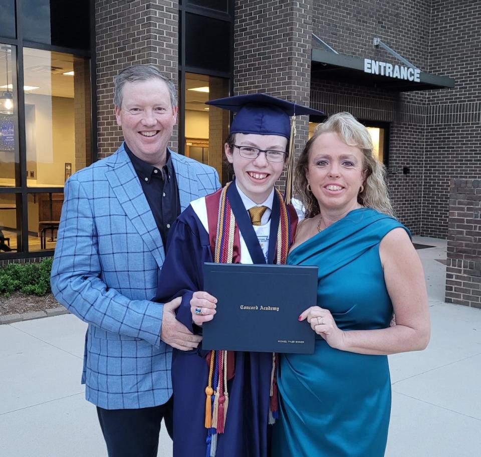 Mike Wimmer and his parents, Melissa and Mark Wimmer, during his high school graduation.