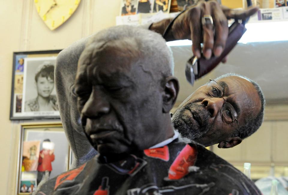 Vernon Winfrey cutting hair at a Nashville barbershop.