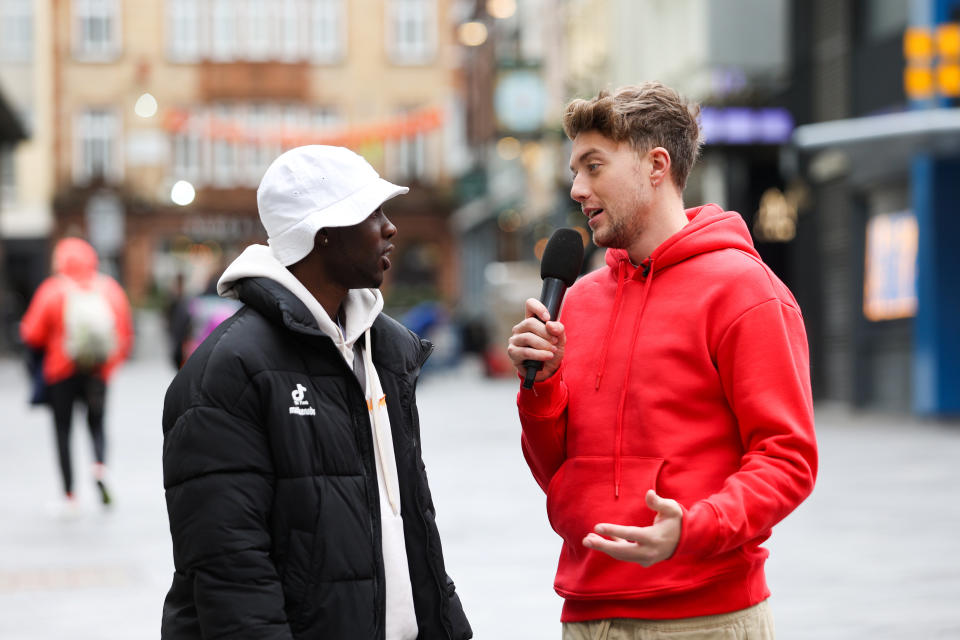 Roman Kemp talking to member of the public on the street about how they respond when asked how they are. (SWNS)