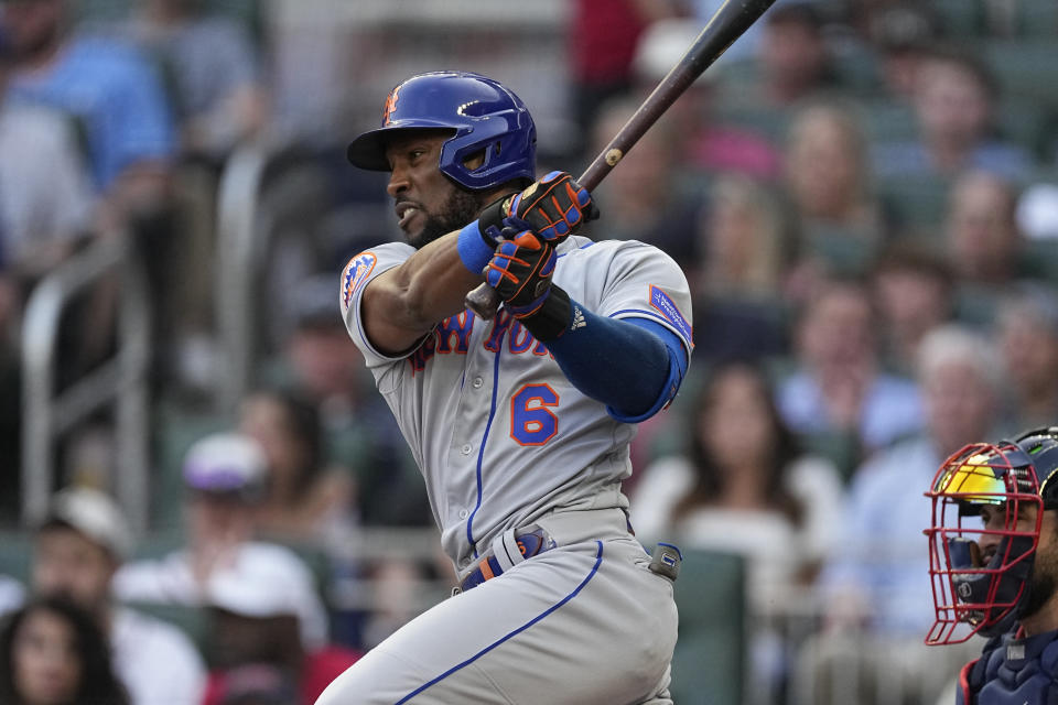 New York Mets' Starling Marte watches his RBI single next to Atlanta Braves catcher Travis d'Arnaud during the second inning of a baseball game Thursday, June 8, 2023, in Atlanta. (AP Photo/John Bazemore)