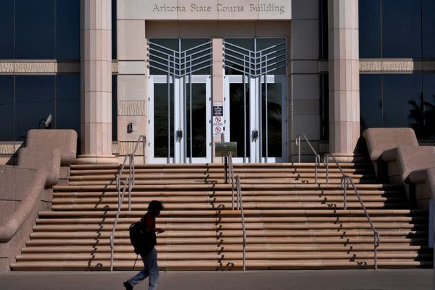 A person walks past the Arizona Supreme Court building, Wednesday, April 10, 2024, in Phoenix. The Arizona Supreme Court ruled Tuesday that the state can enforce its long-dormant law criminalizing all abortions except when a mother's life is at stake. 