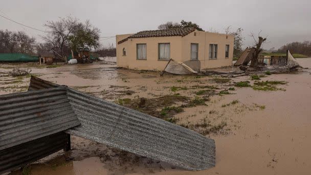 PHOTO: Flood waters inundate a home by the Salinas River near Chualar, California, on on January 14, 2023, as a series of atmospheric river storms continue to cause widespread destruction across the state. (David Mcnew/AFP via Getty Images)