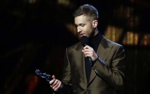 Calvin Harris collects his award for Best British Producer onstage at the Brit Awards in London - Credit: AP