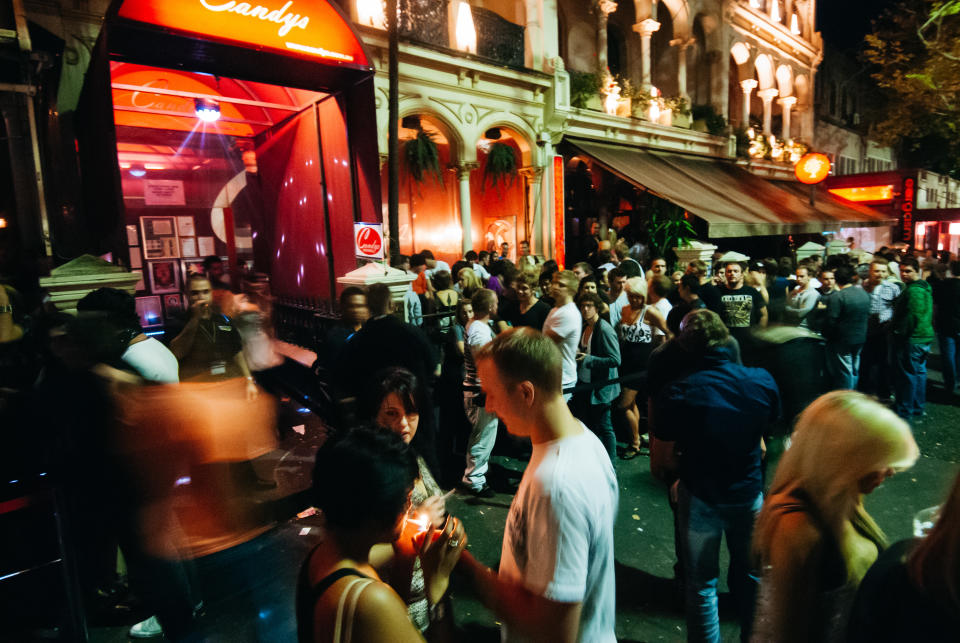 Party goers out the front of club Candy's Apartment. 