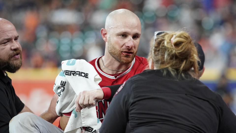 Los Angeles Angels' Jonathan Lucroy, center, is carted off the field after colliding with Houston Astros' Jake Marisnick at home plate during the eighth inning of a baseball game Sunday, July 7, 2019, in Houston. (AP Photo/David J. Phillip)