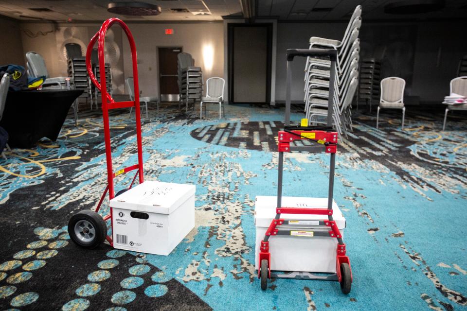 Taped boxes of precinct results are ready to roll out as Johnson County Democrats party officials wrap up work following the caucus, Tuesday, Feb. 4, 2020, at the Radisson Hotel & Conference Center in Coralville, Iowa.