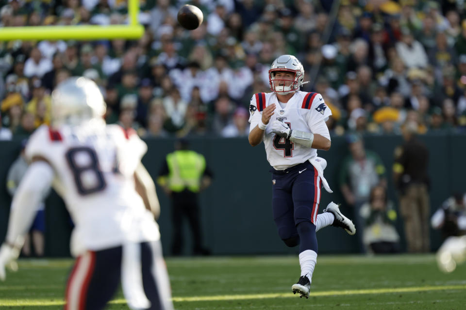 New England Patriots quarterback Bailey Zappe (4) throws a pass during the first half of an NFL football game against the Green Bay Packers, Sunday, Oct. 2, 2022, in Green Bay, Wis. (AP Photo/Matt Ludtke)