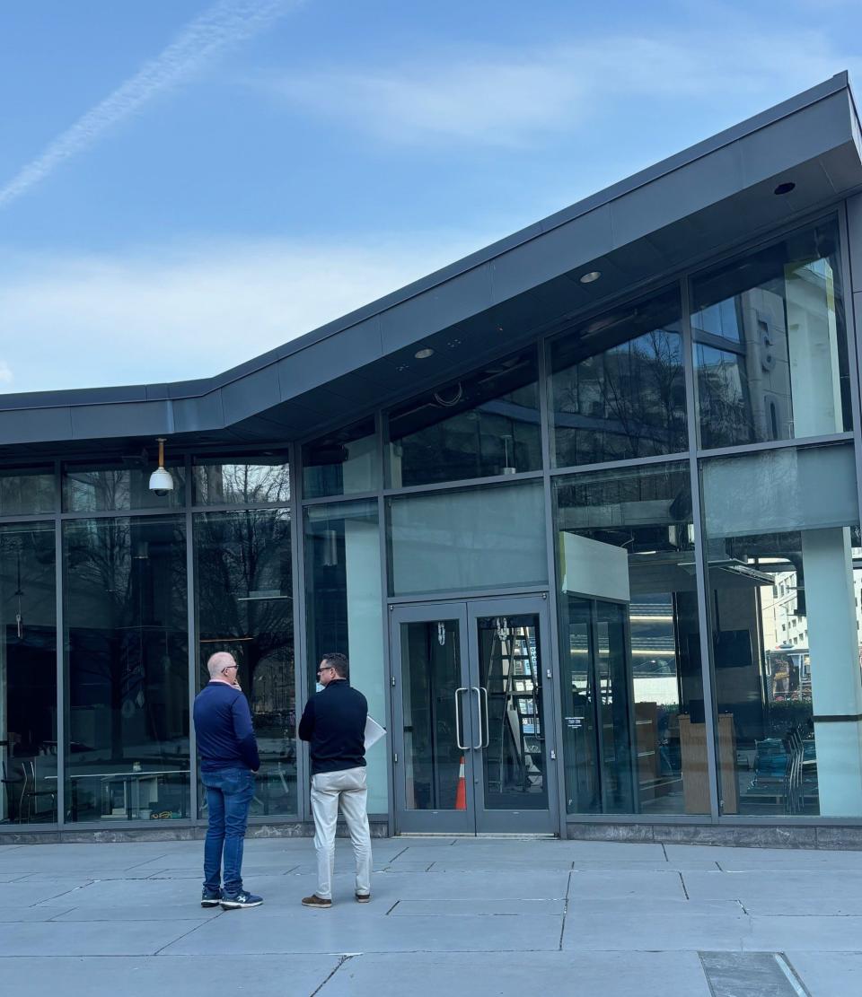 Dan Butler (left) stands outside of his new coming-soon Wilmington restaurant The BlueBird and discusses ideas for a restaurant sign. The breakfast and lunch spot at 500 Delaware Ave. is scheduled to open April 22.