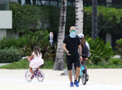 A man wears a mask as he walks along Waikiki Beach in Honolulu on Saturday, March 28, 2020. Like many cities across the world, Honolulu came to an eerie standstill this weekend as the coronavirus pandemic spread throughout the islands. But Hawaii officials went beyond the standard stay-at-home orders and effectively flipped the switch on the state's tourism-fueled economic engine in a bid to slow the spread of the virus. As of Thursday, anyone arriving in Hawaii must undergo a mandatory 14-day self quarantine. The unprecedented move dramatically reduced the number of people on beaches, in city parks and on country roads, the same roads where many people rely on tourism dollars to pay for the high cost of living in Hawaii. (AP Photo/Caleb Jones)