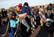 Migrants, part of a caravan of thousands traveling from Central America en route to the United States, push each other as they play together at a makeshift camp at a gas station where the migrants wait for buses in Navojoa, Mexico November 16, 2018. REUTERS/Kim Kyung-Hoon