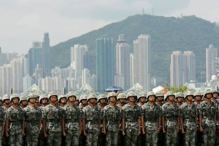 FILE PHOTO: The People's Liberation Army (PLA) soldiers take part in a performance during an open day of Stonecutters Island naval base, in Hong Kong