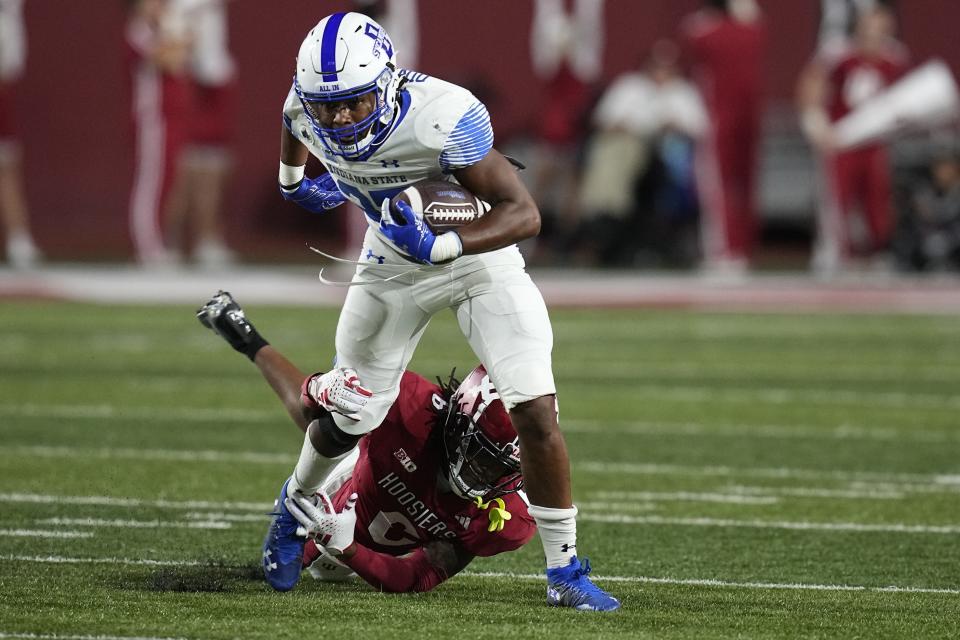 Indiana State running back Justin Dinka, top, is tackled by Indiana defensive back Phillip Dunnam (6) during the second half of an NCAA college football game, Friday, Sept. 8, 2023, in Bloomington, Ind. (AP Photo/Darron Cummings)