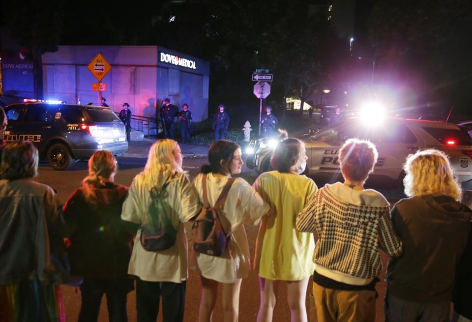 Approximately 100 protesters face-off with Eugene Police deployed in front of Dove Medica during a protest in support of abortion rights in Eugene Friday June 24, 2022.