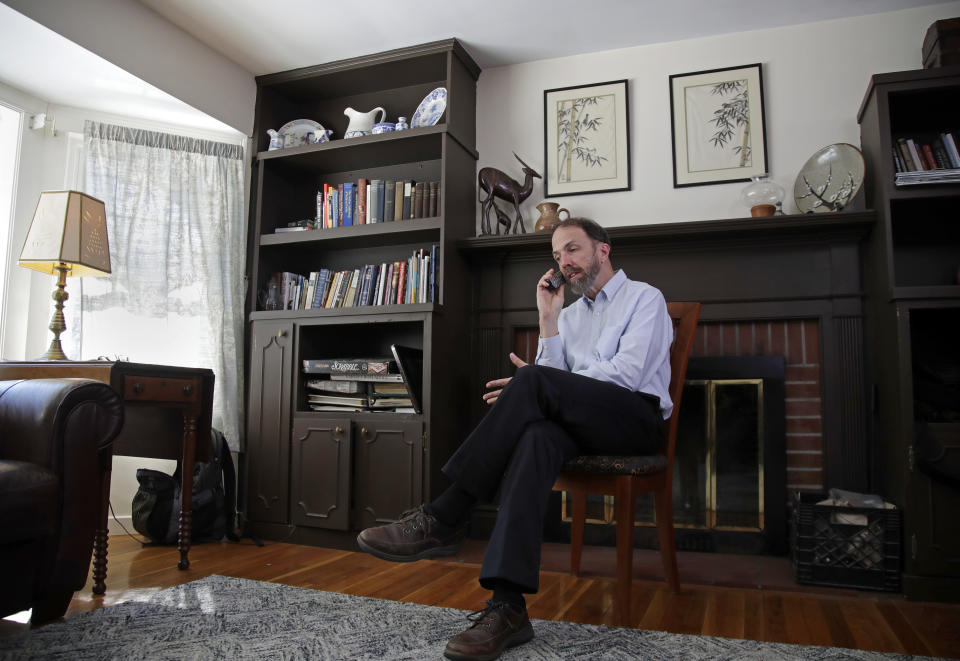 In this Jan. 30, 2019 photo, Dr. Rick Sacra speaks to a reporter by phone at his Holden, Mass. home. Sacra, a Massachusetts doctor who was among a handful of Americans treated and cured of Ebola in 2014, is being honored for his work in Liberia through the deadly epidemic. (AP Photo/Elise Amendola)