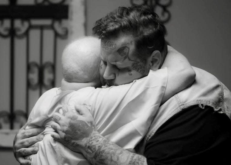 Jelly Roll hugs fan Suzanne Durham in July at Life Church Nashville. The hip-hop and country star gave a private concert for Durham, who has Stage 4 cancer and said meeting Jelly Roll was her dying wish.