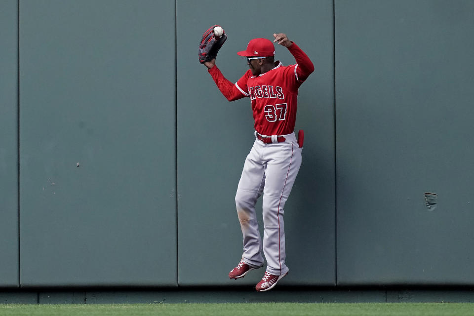 Los Angeles Angels center fielder Magneuris Sierra catches a fly ball for the out on Kansas City Royals' Michael A. Taylor during the the ninth inning of a baseball game Wednesday, July 27, 2022, in Kansas City, Mo. The Angels won 4-0. (AP Photo/Charlie Riedel)