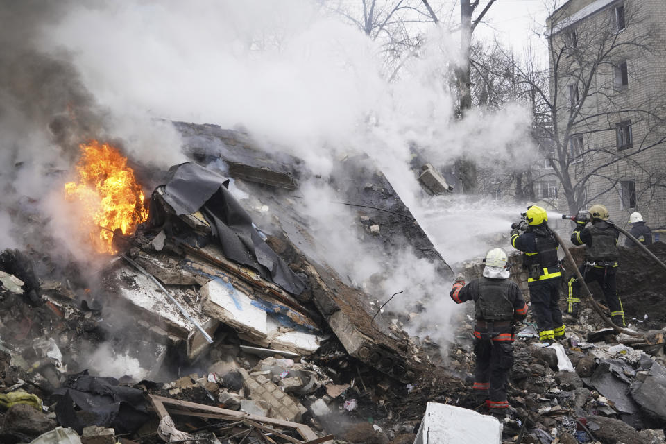 Rescuers work the scene of a building damaged by a Russian rocket attack in Kharkiv, Ukraine, Tuesday, Jan. 23, 2024. (AP Photo/Andrii Marienko)